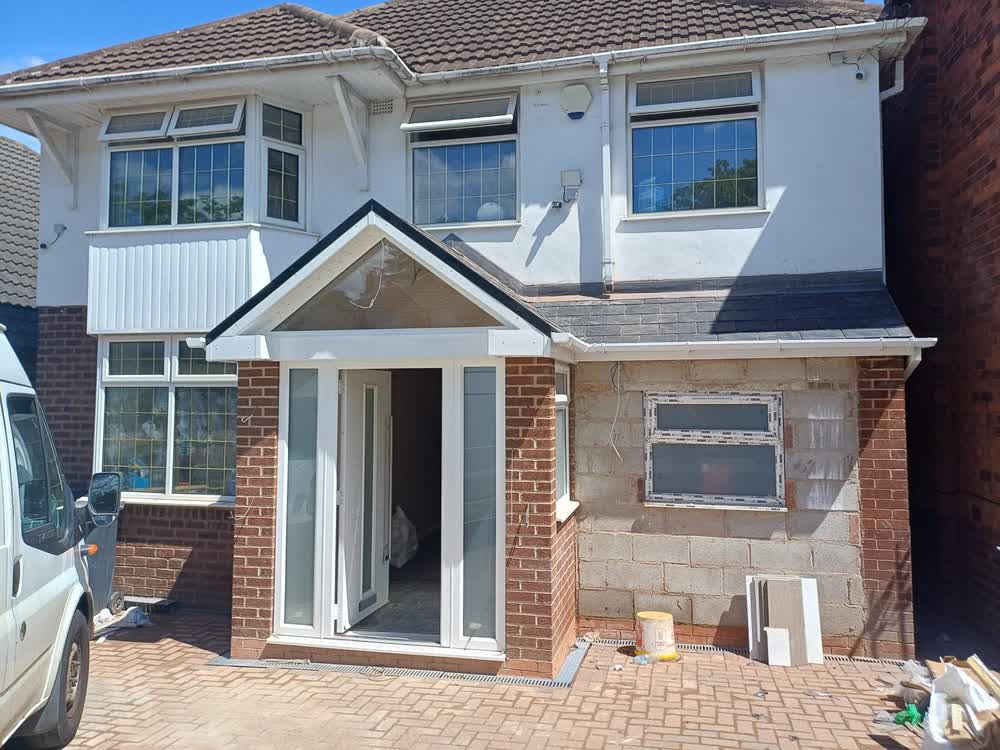 Brick porch with a new tiled roof and a white front door